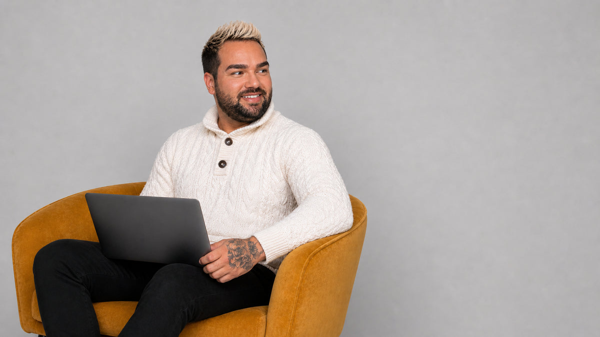 Randy from Viber smiling in an armchair with a laptop